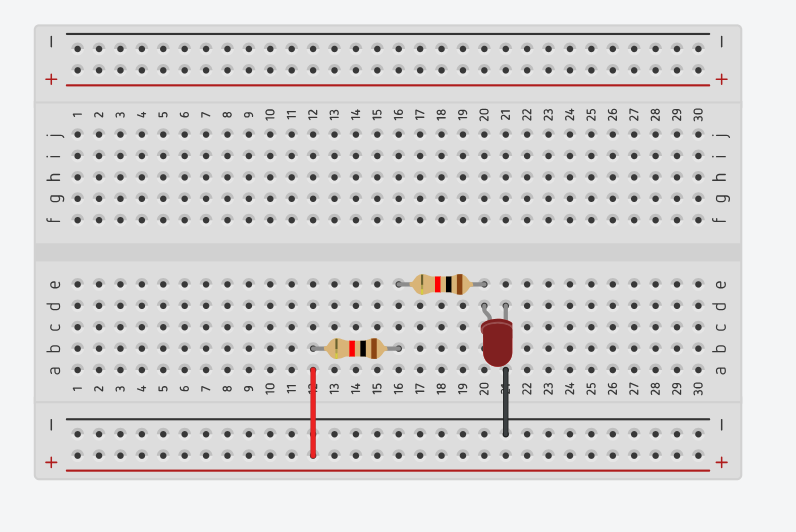 Breadboard wired with two resistors and an LED connected in series